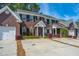 Charming brick townhouses each featuring driveways, and meticulously maintained landscaping at 219 Tuscany Ct, Ladson, SC 29456