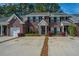 Elegant brick townhouses with a private driveway and well-maintained front landscaping at 219 Tuscany Ct, Ladson, SC 29456