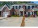 Inviting brick townhouse showcasing a well-maintained front yard and classic black shutters at 219 Tuscany Ct, Ladson, SC 29456