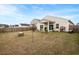 Expansive backyard with a well-maintained lawn, privacy fence, and covered patio, ideal for outdoor activities at 226 Clydesdale Cir, Summerville, SC 29486