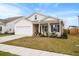 Charming single-story home features a covered porch, well-maintained landscaping and a two-car garage at 226 Clydesdale Cir, Summerville, SC 29486
