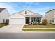 Inviting single-story home features a covered porch, well-maintained landscaping, and two-car garage at 226 Clydesdale Cir, Summerville, SC 29486