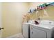Functional laundry room featuring a washer and dryer, plus a shelf for storage and organization at 226 Clydesdale Cir, Summerville, SC 29486