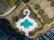 Aerial view of community pool with unique clover shape, sunbathing deck, and manicured landscaping at 233 S Plaza Ct # 210, Mount Pleasant, SC 29464
