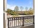 View from the balcony overlooking the meticulously landscaped grounds and elegant entryway of the property at 233 S Plaza Ct # 210, Mount Pleasant, SC 29464