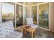 Outdoor balcony featuring slate floors, wooden chairs and a table looking into the main bedroom through sliding glass doors at 233 S Plaza Ct # 210, Mount Pleasant, SC 29464