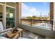 Outdoor balcony with brick accents, stone flooring, wrought iron railing, and views of the bridge and pool at 233 S Plaza Ct # 210, Mount Pleasant, SC 29464