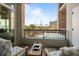 Outdoor balcony with views of the bridge, pool, and landscaping, with chairs and a small wooden table at 233 S Plaza Ct # 210, Mount Pleasant, SC 29464