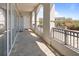 Spacious balcony with stone floors, arched supports, and metal railing showcasing the building's architecture at 233 S Plaza Ct # 210, Mount Pleasant, SC 29464