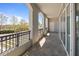 Inviting balcony features stone floors, arches, and metal railing, with a glimpse of the surrounding neighborhood at 233 S Plaza Ct # 210, Mount Pleasant, SC 29464