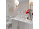 Bathroom featuring a single sink vanity, mirror, lighting, and red flowers at 233 S Plaza Ct # 210, Mount Pleasant, SC 29464