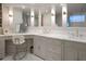 Bathroom with double sinks, large vanity, and a large mirror with built in lighting, next to a make up mirror at 233 S Plaza Ct # 210, Mount Pleasant, SC 29464