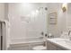 Bathroom featuring a shower-tub, white tiling, and single sink vanity at 233 S Plaza Ct # 210, Mount Pleasant, SC 29464