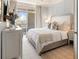 Cozy bedroom with a large bed, patterned wallpaper, and access to a balcony with scenic views at 233 S Plaza Ct # 210, Mount Pleasant, SC 29464
