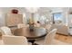 Bright dining area featuring a round wood table, upholstered chairs, and decorative chandelier open to the living area at 233 S Plaza Ct # 210, Mount Pleasant, SC 29464