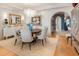 Dining room with wood floors, chandelier, and arched doorway showcases open layout at 233 S Plaza Ct # 210, Mount Pleasant, SC 29464