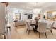 Open floorplan showcases living room with dining area, chandelier, and hardwood floors at 233 S Plaza Ct # 210, Mount Pleasant, SC 29464