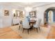 Bright dining room with chandelier, wood floors, neutral rug, and elegant furnishings at 233 S Plaza Ct # 210, Mount Pleasant, SC 29464