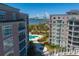 Beautiful exterior view of buildings, pool, and pergola, capturing waterfront views of the bridge at 233 S Plaza Ct # 210, Mount Pleasant, SC 29464