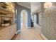 Elegant hallway with arched doorways, built-in shelving, and stylish wallpaper at 233 S Plaza Ct # 210, Mount Pleasant, SC 29464