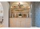 Built-in shelving showcases books, art, and decorative objects against patterned wallpaper at 233 S Plaza Ct # 210, Mount Pleasant, SC 29464