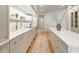 Bright kitchen features marble countertops, gold hardware, and an island with wooden floors at 233 S Plaza Ct # 210, Mount Pleasant, SC 29464