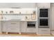 Modern kitchen with stainless steel double oven, microwave, and marble countertops at 233 S Plaza Ct # 210, Mount Pleasant, SC 29464