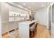 Open-concept kitchen with an island, marble counters, modern appliances, and wood floors at 233 S Plaza Ct # 210, Mount Pleasant, SC 29464