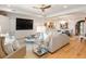 Spacious living room with hardwood floors, a large television, modern decor, and an adjacent dining area at 233 S Plaza Ct # 210, Mount Pleasant, SC 29464