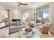 Bright living area featuring a cozy seating area, fireplace, and views of the outside from a private balcony at 233 S Plaza Ct # 210, Mount Pleasant, SC 29464