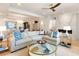 Open-concept living area with comfortable seating, a stylish coffee table, and view to dining area and fireplace at 233 S Plaza Ct # 210, Mount Pleasant, SC 29464