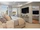 Bedroom featuring large bed, night stand, TV on the wall, and doorway to an office and living room at 233 S Plaza Ct # 210, Mount Pleasant, SC 29464
