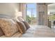 Bedroom featuring large bed, a window with bridge views, and doorway to an adjoining room with a desk at 233 S Plaza Ct # 210, Mount Pleasant, SC 29464