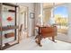 Bright office with sit-stand desk, glass shelving, and access to a balcony with a view of the outdoors at 233 S Plaza Ct # 210, Mount Pleasant, SC 29464