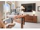 Modern office with a sit-stand desk, wooden credenza, and large windows offering plenty of natural light at 233 S Plaza Ct # 210, Mount Pleasant, SC 29464