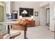 Well-lit office space featuring a sit-stand desk, a television, and access to a private balcony at 233 S Plaza Ct # 210, Mount Pleasant, SC 29464