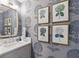 Stylish powder room boasting patterned wallpaper, framed floral prints, and a sleek vanity at 233 S Plaza Ct # 210, Mount Pleasant, SC 29464