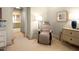 Sitting room with comfortable chair, dresser, carpeted floor, and a view into an on-suite bathroom at 233 S Plaza Ct # 210, Mount Pleasant, SC 29464