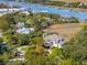 Stunning aerial view of the luxurious waterfront home surrounded by mature trees and a winding driveway at 24 Waterway Island Dr, Isle of Palms, SC 29451