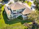 Expansive home with lush landscaping, a multi-tiered deck, and a sprawling green lawn at 24 Waterway Island Dr, Isle of Palms, SC 29451