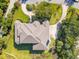 Aerial view of grand estate featuring lush landscaping, mature trees, and a circular driveway at 24 Waterway Island Dr, Isle of Palms, SC 29451