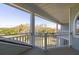 Covered balcony with white railings offering scenic views of lush greenery and blue skies at 24 Waterway Island Dr, Isle of Palms, SC 29451