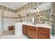Beautifully tiled bathroom boasts a large mirror, a walk-in shower, and wooden cabinets at 24 Waterway Island Dr, Isle of Palms, SC 29451