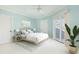 Bright bedroom with light blue walls, a ceiling fan, and sliding doors leading to a balcony at 24 Waterway Island Dr, Isle of Palms, SC 29451