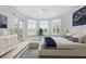 Beautiful bedroom with ample natural light, a sitting area, and chic modern decor at 24 Waterway Island Dr, Isle of Palms, SC 29451