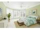 Bright bedroom with a ceiling fan, bay window, and coordinated decor in soft green tones at 24 Waterway Island Dr, Isle of Palms, SC 29451