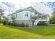 Well-manicured lawn with lush greenery and landscaping surrounding a beautiful home at 24 Waterway Island Dr, Isle of Palms, SC 29451