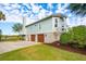 Charming home with wood siding, double garages, chimney, and a well-manicured lawn at 24 Waterway Island Dr, Isle of Palms, SC 29451