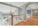 Upper level landing with a view of the lower floor, showcasing a chandelier and vaulted ceilings at 24 Waterway Island Dr, Isle of Palms, SC 29451