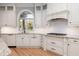 Bright kitchen featuring custom cabinetry, granite countertops, and modern appliances at 24 Waterway Island Dr, Isle of Palms, SC 29451